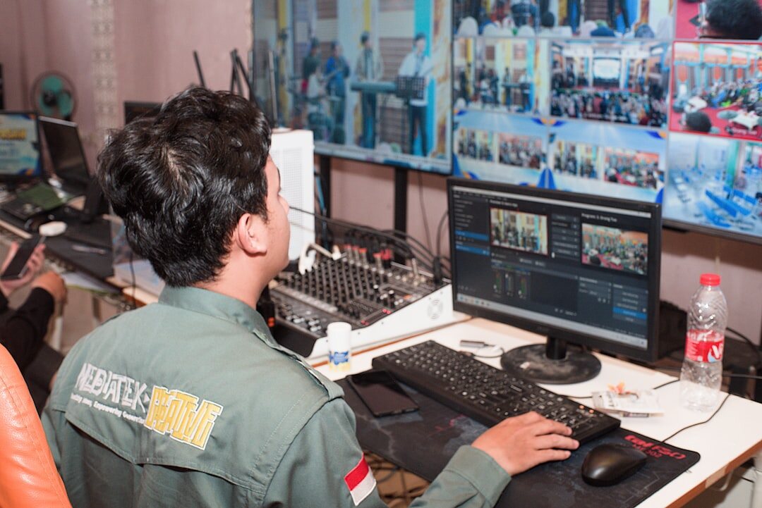 Broadcast control room with multiple video monitors and switcher