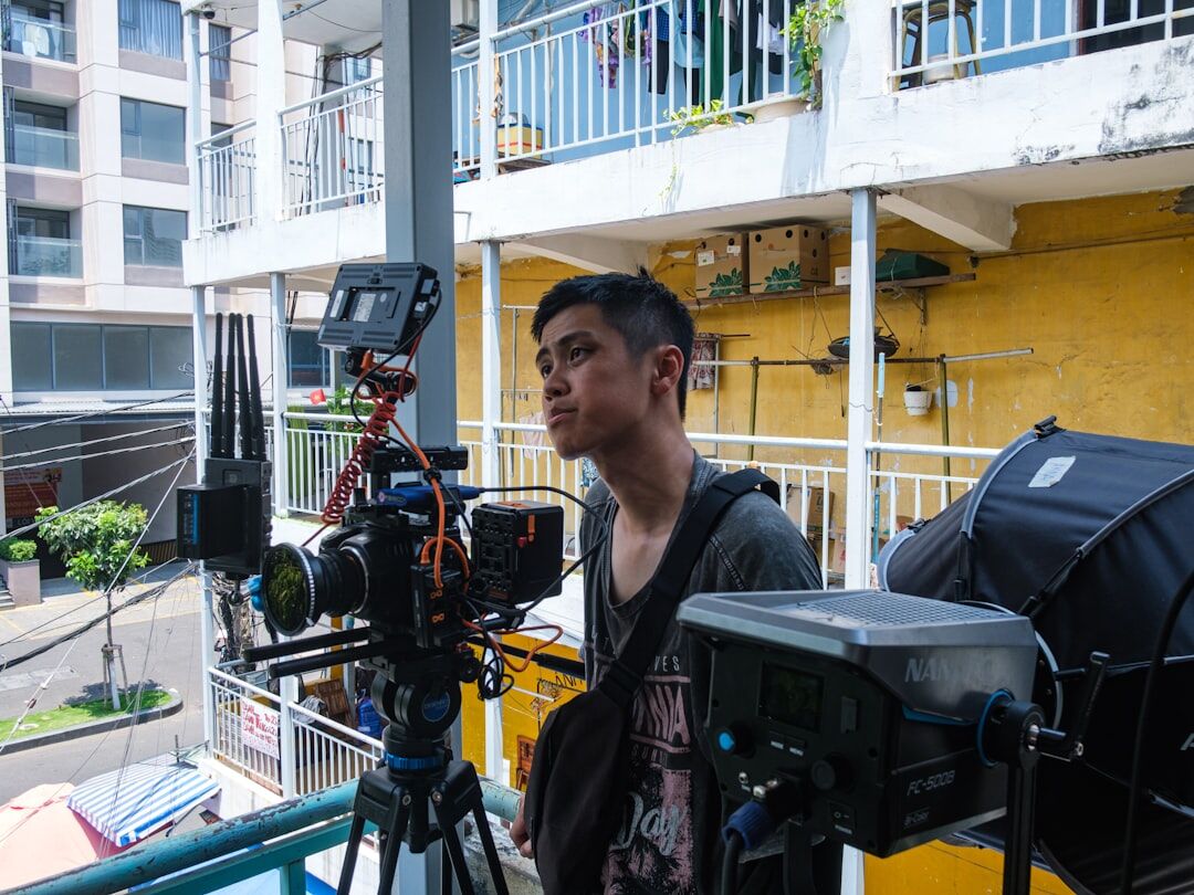 Field reporter holding a microphone during an outdoor broadcast